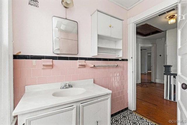 224 Hamilton Ave, Colonial Heights, VA 23834 - bathroom with tile walls, vanity, wainscoting, and tile patterned flooring