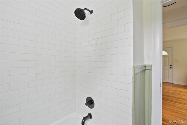 8467 Shady Grove Rd, Mechanicsville, VA 23116 - bathroom view of tub / shower combination, ornamental molding, and wood finished floors