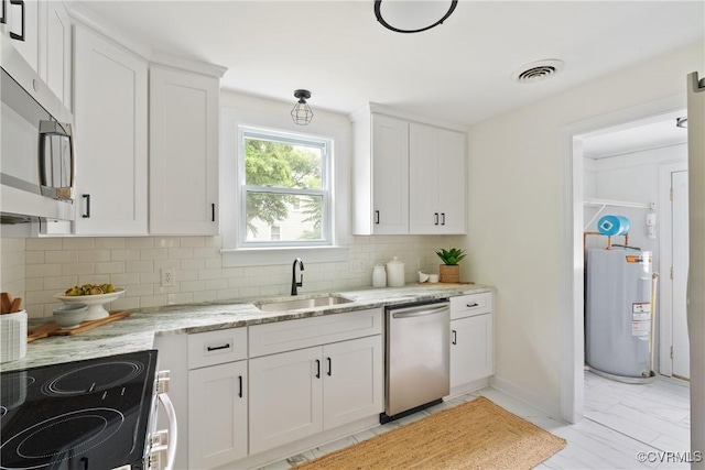 8467 Shady Grove Rd, Mechanicsville, VA 23116 - kitchen featuring appliances with stainless steel finishes, water heater, tasteful backsplash, and white cabinets