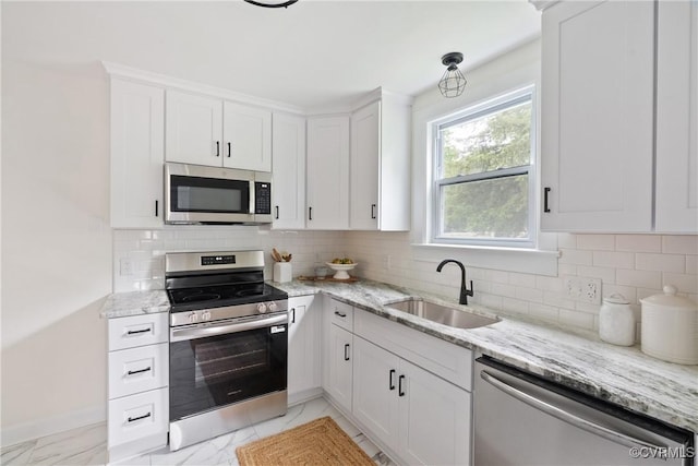 8467 Shady Grove Rd, Mechanicsville, VA 23116 - kitchen with appliances with stainless steel finishes, white cabinets, light stone countertops, light marble finish flooring, and tasteful backsplash
