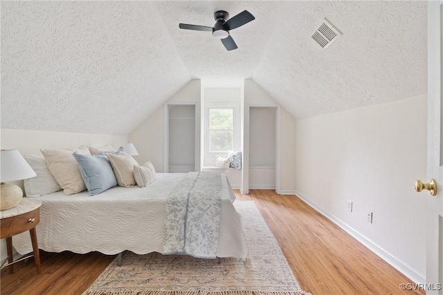 8467 Shady Grove Rd, Mechanicsville, VA 23116 - bedroom with a textured ceiling, light wood finished floors, ceiling fan, and lofted ceiling