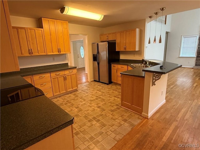 14005 Cooperton Cir, Chester, VA 23836 - kitchen with stainless steel fridge with ice dispenser, a peninsula, a kitchen bar, and dark countertops