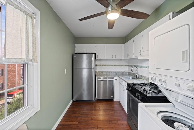 21 Rock Garden Ln, Henrico, VA 23228 - kitchen featuring appliances with stainless steel finishes, stacked washer / drying machine, dark wood-type flooring, white cabinetry, and ceiling fan