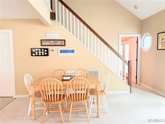4030 Wellfords Wharf Rd, Warsaw, VA 22572 - dining area with carpet floors, vaulted ceiling, and stairway