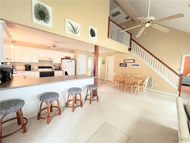 4030 Wellfords Wharf Rd, Warsaw, VA 22572 - kitchen with white appliances, ceiling fan, high vaulted ceiling, and light colored carpet