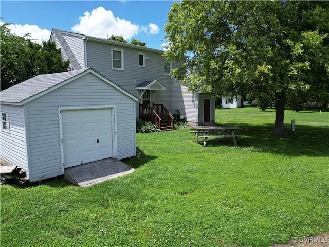 4030 Wellfords Wharf Rd, Warsaw, VA 22572 - back of property featuring an outdoor structure, a garage, a yard, and a shingled roof