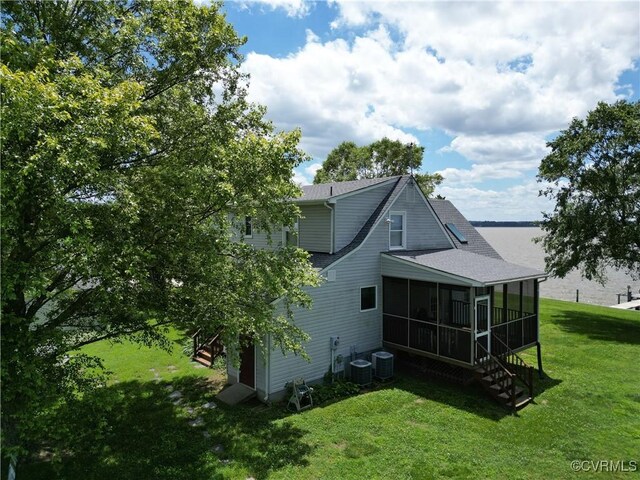 4030 Wellfords Wharf Rd, Warsaw, VA 22572 - back of property featuring a sunroom, a yard, stairway, and a shingled roof