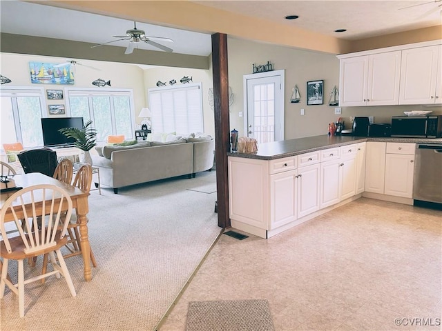 4030 Wellfords Wharf Rd, Warsaw, VA 22572 - kitchen with black microwave, stainless steel dishwasher, a ceiling fan, white cabinetry, and a peninsula