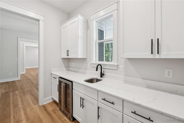 5-6 Pocahontas Trl, Providence Forge, VA 23089 - kitchen featuring wine cooler, white cabinetry, light wood-style flooring, and light stone countertops