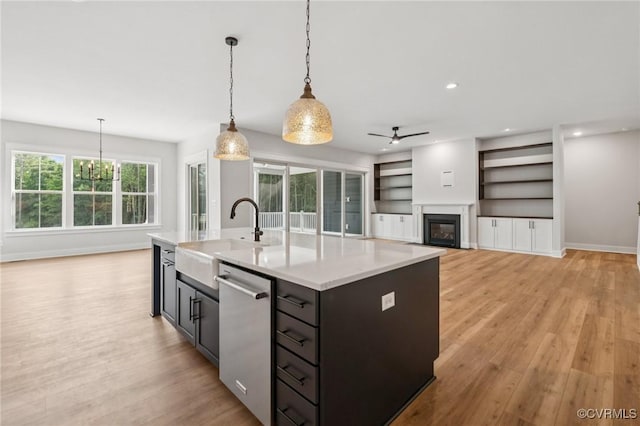 5-6 Pocahontas Trl, Providence Forge, VA 23089 - kitchen with dishwasher, ceiling fan, a glass covered fireplace, light countertops, and decorative light fixtures