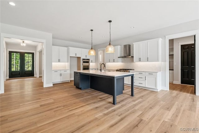 5-6 Pocahontas Trl, Providence Forge, VA 23089 - kitchen with wall chimney range hood, white cabinets, decorative backsplash, light countertops, and recessed lighting