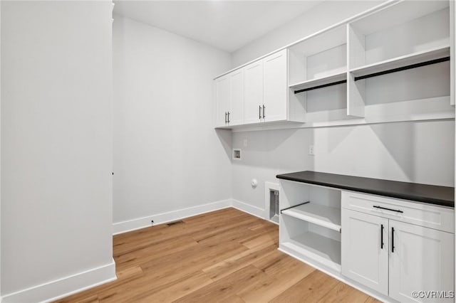 5-6 Pocahontas Trl, Providence Forge, VA 23089 - washroom featuring hookup for a washing machine, electric dryer hookup, light wood-style flooring, and cabinet space