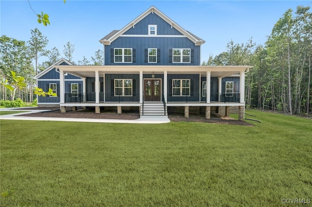 5-6 Pocahontas Trl, Providence Forge, VA 23089 - view of front of house with board and batten siding, a front yard, and a porch