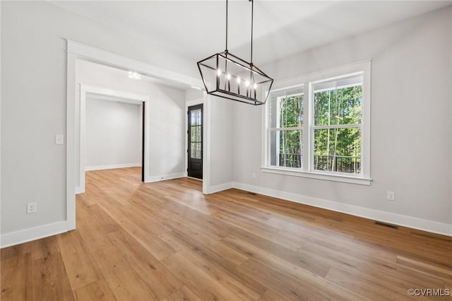 5-6 Pocahontas Trl, Providence Forge, VA 23089 - unfurnished dining area featuring a chandelier, plenty of natural light, and light wood-style floors