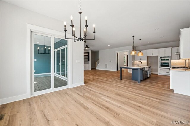 5-6 Pocahontas Trl, Providence Forge, VA 23089 - kitchen with a chandelier, open floor plan, white cabinetry, light wood finished floors, and recessed lighting