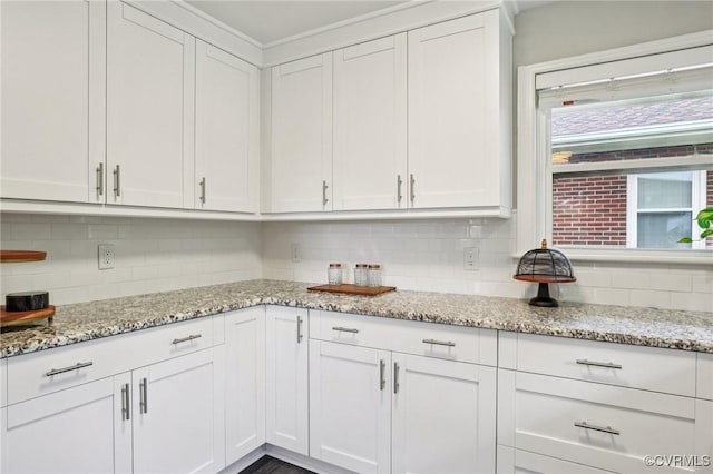 610 N 39th St, Richmond, VA 23223 - kitchen with decorative backsplash, white cabinets, and light stone counters