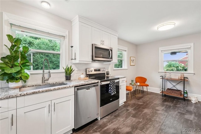610 N 39th St, Richmond, VA 23223 - kitchen featuring appliances with stainless steel finishes, healthy amount of natural light, and backsplash
