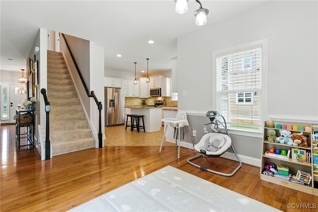 2201 Vandover Rd, Henrico, VA 23229 - sitting room with light wood-style flooring, stairway, healthy amount of natural light, and recessed lighting