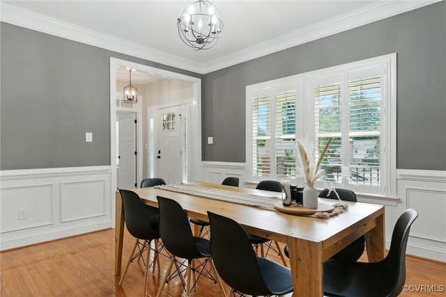 2201 Vandover Rd, Henrico, VA 23229 - dining space with a decorative wall, wainscoting, crown molding, a chandelier, and light wood-style floors