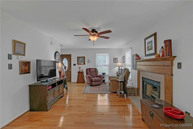 6661 Powhatan Dr, Hayes, VA 23072 - living area with a ceiling fan, light wood-type flooring, and a tile fireplace