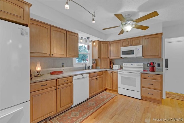 6661 Powhatan Dr, Hayes, VA 23072 - kitchen with white appliances, backsplash, light countertops, ceiling fan, and light wood-type flooring