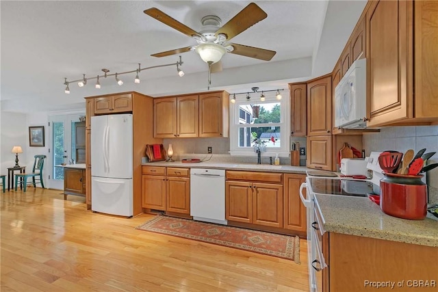6661 Powhatan Dr, Hayes, VA 23072 - kitchen with white appliances, light wood-type flooring, brown cabinets, and a ceiling fan