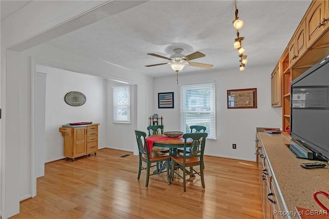 6661 Powhatan Dr, Hayes, VA 23072 - dining room with light wood finished floors, ceiling fan, and a textured ceiling