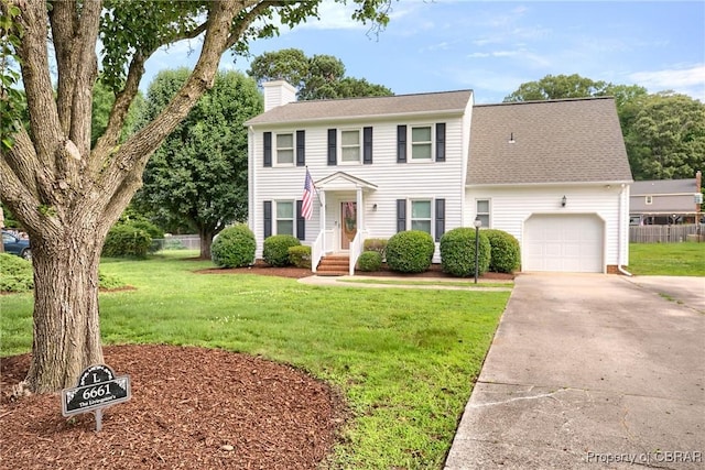 6661 Powhatan Dr, Hayes, VA 23072 - colonial inspired home featuring a chimney, a garage, driveway, and roof with shingles