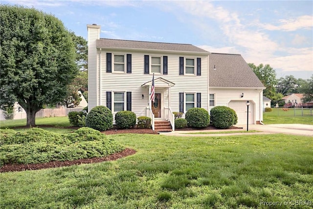 6661 Powhatan Dr, Hayes, VA 23072 - colonial home featuring a chimney, an attached garage, and concrete driveway