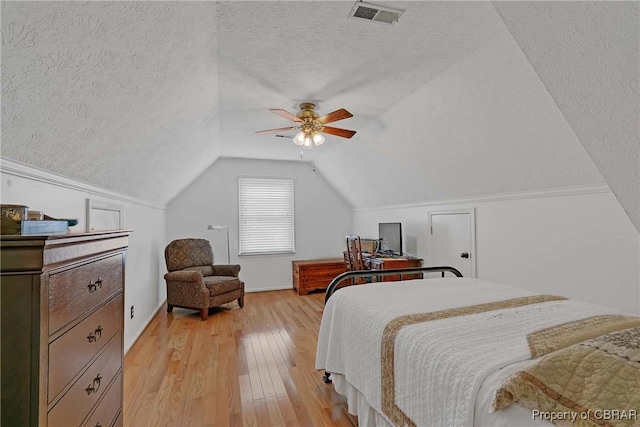 6661 Powhatan Dr, Hayes, VA 23072 - bedroom with a textured ceiling, light wood-type flooring, vaulted ceiling, and a ceiling fan