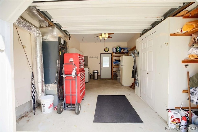 6661 Powhatan Dr, Hayes, VA 23072 - garage featuring freestanding refrigerator, washer / dryer, and a ceiling fan