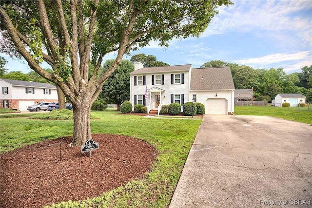 6661 Powhatan Dr, Hayes, VA 23072 - colonial inspired home featuring a garage, a chimney, driveway, and roof with shingles