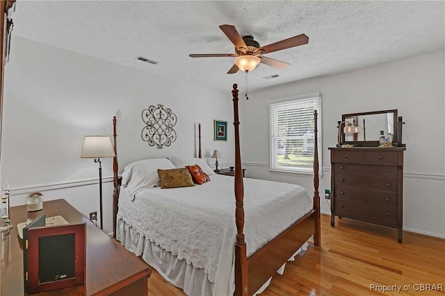 6661 Powhatan Dr, Hayes, VA 23072 - bedroom featuring wood finished floors, a textured ceiling, and a ceiling fan
