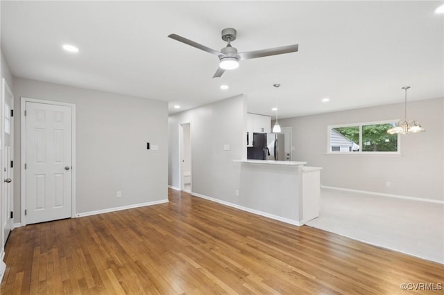 8238 Lansdowne Rd, Mechanicsville, VA 23116 - unfurnished living room with ceiling fan, light wood-style flooring, a chandelier, and recessed lighting