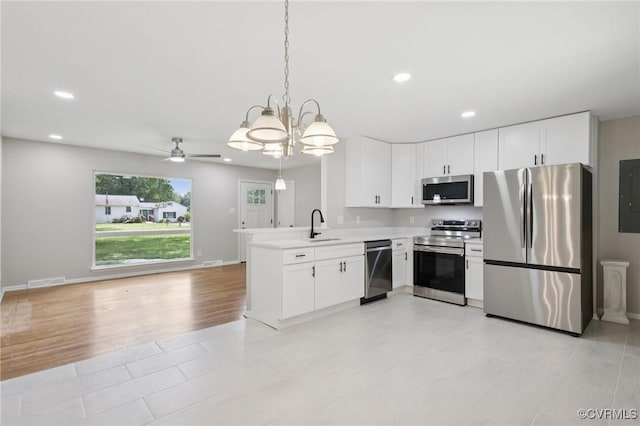 8238 Lansdowne Rd, Mechanicsville, VA 23116 - kitchen with stainless steel appliances, a chandelier, recessed lighting, white cabinetry, and light countertops