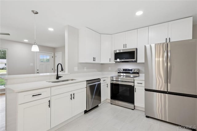 8238 Lansdowne Rd, Mechanicsville, VA 23116 - kitchen with stainless steel appliances, light countertops, a peninsula, white cabinetry, and hanging light fixtures