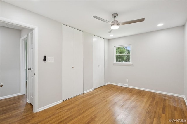 8238 Lansdowne Rd, Mechanicsville, VA 23116 - unfurnished bedroom with light wood-style flooring, two closets, a ceiling fan, and recessed lighting