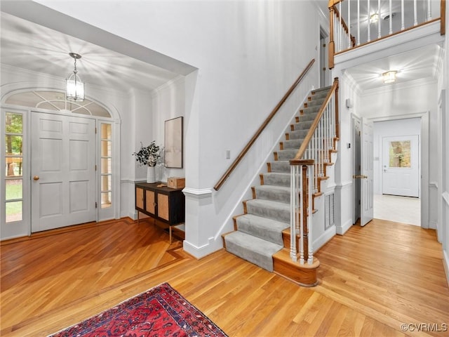 9313 Owl Trace Ct, Chesterfield, VA 23838 - entryway featuring wood finished floors, crown molding, stairway, and a decorative wall