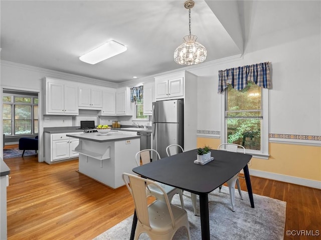 9313 Owl Trace Ct, Chesterfield, VA 23838 - kitchen featuring stainless steel appliances, white cabinets, a kitchen island, light wood-style flooring, and ornamental molding