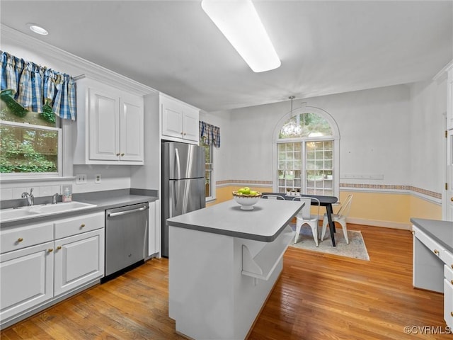 9313 Owl Trace Ct, Chesterfield, VA 23838 - kitchen featuring stainless steel appliances, white cabinets, light wood-style flooring, a center island, and pendant lighting