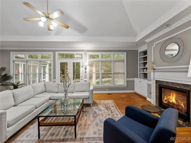 9313 Owl Trace Ct, Chesterfield, VA 23838 - living area featuring lofted ceiling, wood finished floors, a fireplace, built in shelves, and plenty of natural light