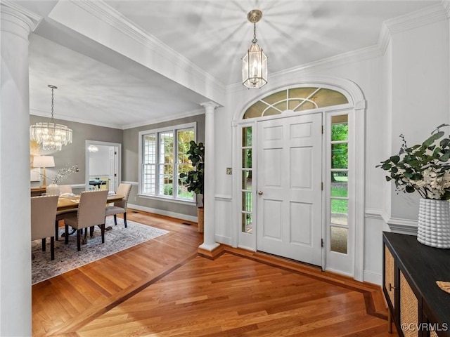 9313 Owl Trace Ct, Chesterfield, VA 23838 - entrance foyer with a chandelier, light wood-style flooring, ornate columns, and crown molding