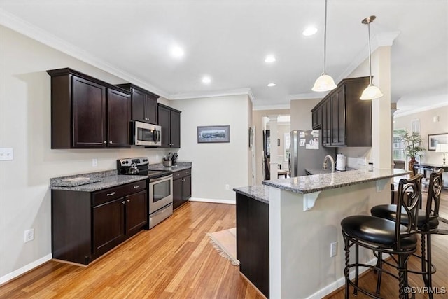 206 Twin Crest Dr, Chesterfield, VA 23236 - kitchen featuring appliances with stainless steel finishes, ornamental molding, a breakfast bar, dark brown cabinetry, and light stone countertops