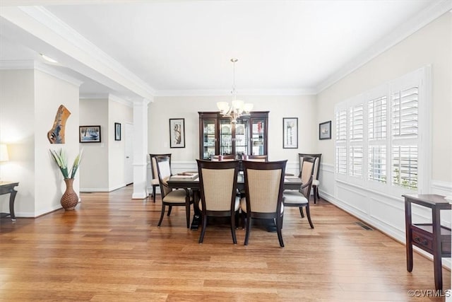 206 Twin Crest Dr, Chesterfield, VA 23236 - dining room with plenty of natural light, light wood finished floors, a chandelier, ornamental molding, and ornate columns