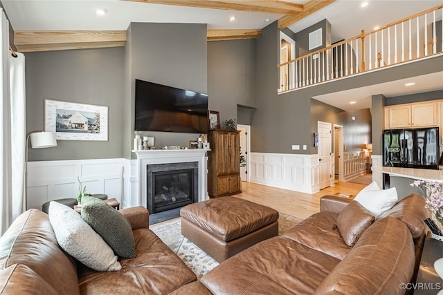 15813 Maclear Dr, Midlothian, VA 23112 - living room with a decorative wall, a towering ceiling, beamed ceiling, recessed lighting, and wainscoting