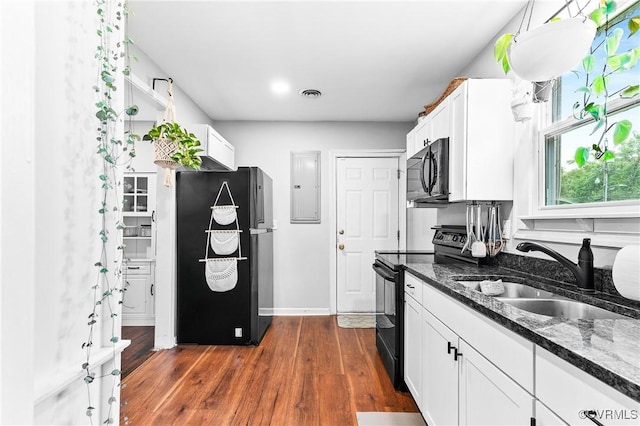 1426 Overlook St, Ampthill, VA 23224 - kitchen with black appliances, electric panel, white cabinets, dark stone counters, and dark wood-style flooring