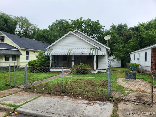 132 Ash Ave, Newport News, VA 23607 - shotgun-style home with a gate and a fenced front yard