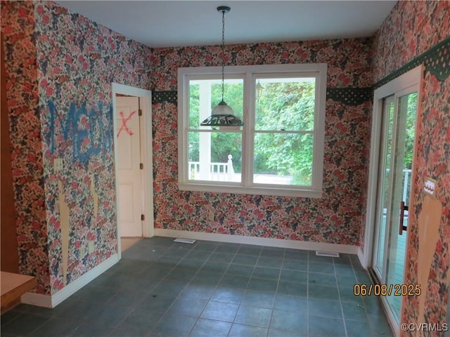 9630 Beaver Bridge Rd, Chesterfield, VA 23838 - unfurnished dining area featuring dark tile patterned floors and wallpapered walls