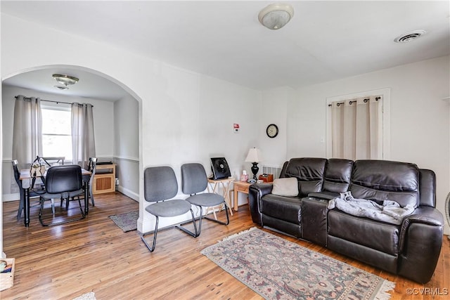 18 E 36th St, Richmond, VA 23224 - living room featuring arched walkways and light wood-style flooring