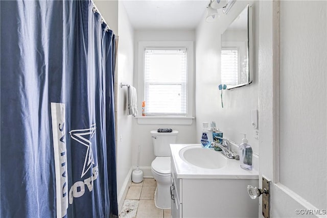 18 E 36th St, Richmond, VA 23224 - full bath with tile patterned floors, plenty of natural light, vanity, and curtained shower